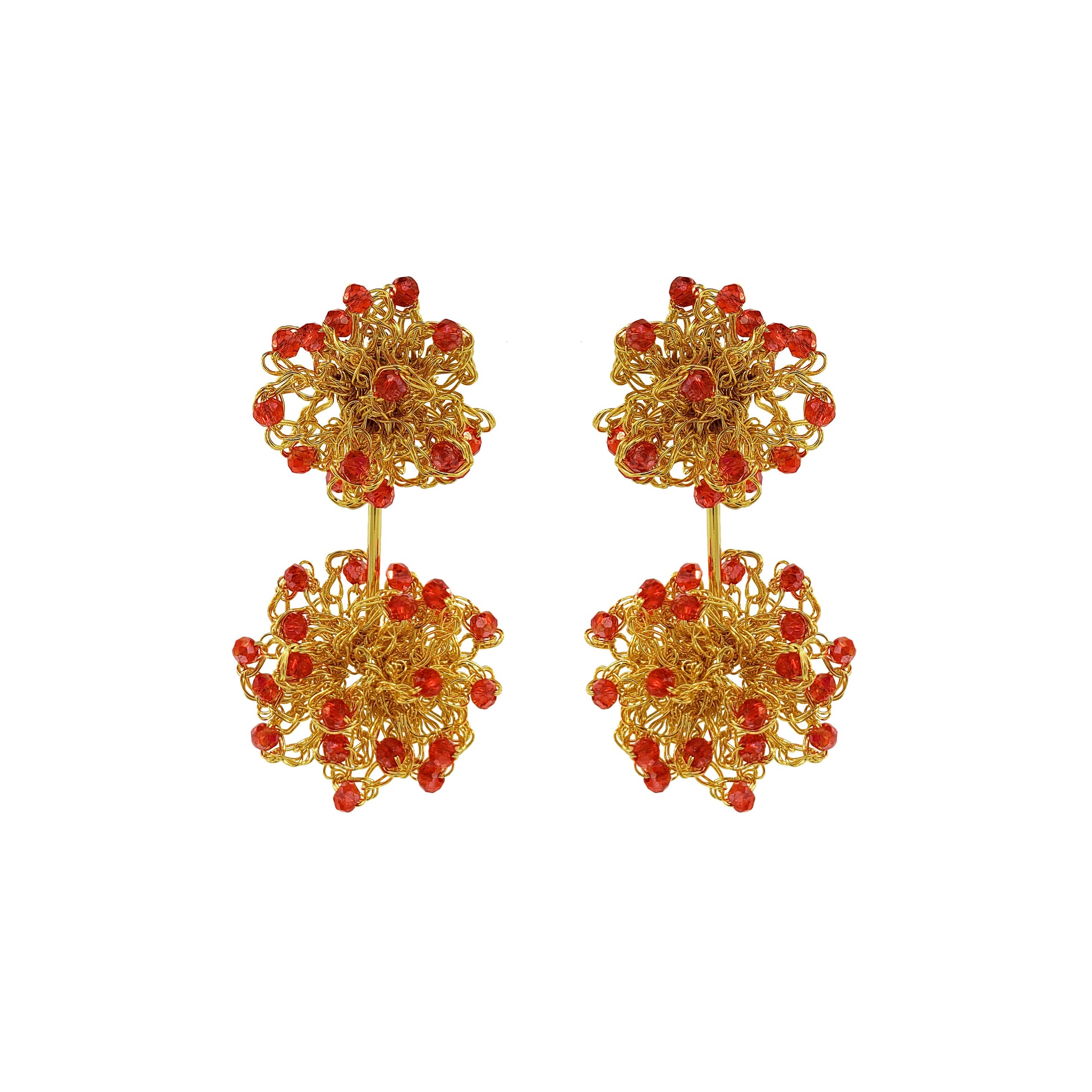 Gold earrings with red beads on a white background. Hand-crocheted double mandala earrings made with 18 karat gold filled wire and red bead accents