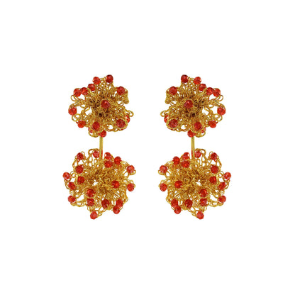 Gold earrings with red beads on a white background. Hand-crocheted double mandala earrings made with 18 karat gold filled wire and red bead accents
