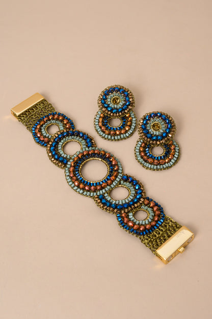 Riviera Mix Gush handmade crochet bracelet featuring layered circles with blue, sage green and bronze crystals, gold-filled wire and magnetic clasp.