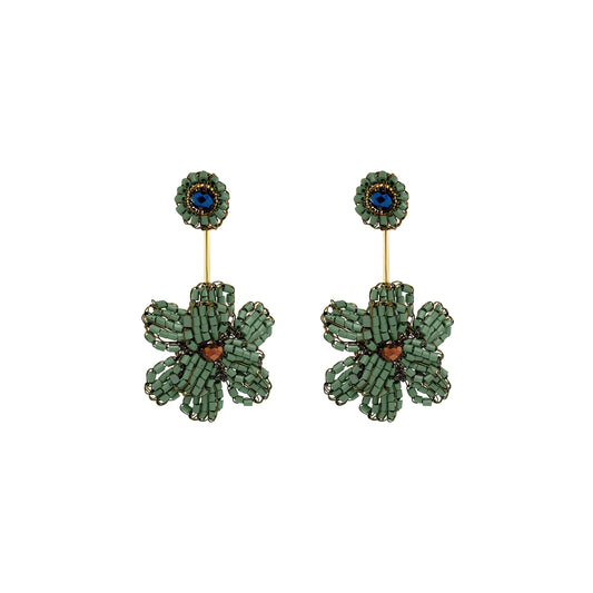 A pair of handmade beaded flower drop earrings featuring textured green petals, a central copper-brown bead, and a blue stone set in a gold-tone circular stud. Shop Riviera Mix Blossom Drop Earrings, handcrafted in Brazil with 18K gold filled and enameled wire. Lightweight floral statement earrings with colorful details.