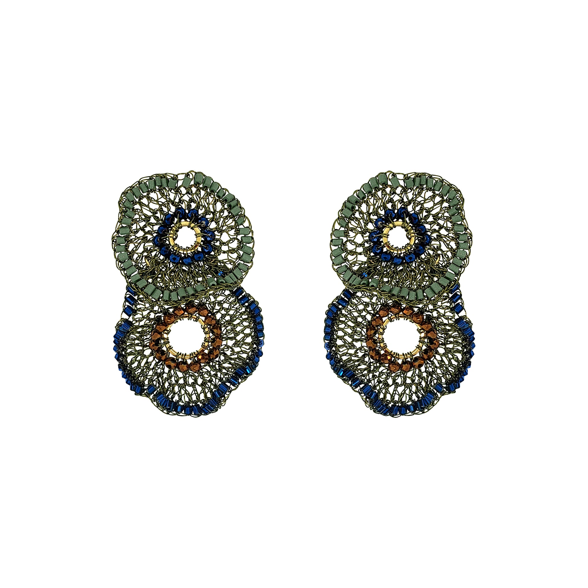 A pair of large, circular beaded earrings with a layered design. The earrings feature textured green, deep blue, and brown beaded rings with openwork centers, set against a plain white background. Shop Riviera Mix Crista Duo Earrings, handcrafted in Brazil with 18K gold filled and enameled wire. Lightweight statement earrings with colorful bead accents.