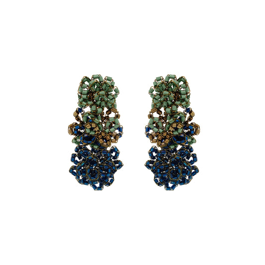 Gold earrings with turquoise stones on a white background. Shop Riviera Mix Drizzle Cascade Earrings, handcrafted in Brazil with 18K gold filled wire and colorful beads. Lightweight, dimensional statement earrings.