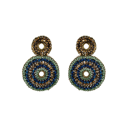 A pair of handmade beaded dangle earrings featuring concentric circular patterns in olive green, navy blue, and metallic gold on a plain white background. Discover Riviera Mix Gia Duo Earrings, hand-crocheted in Brazil with 18K gold-filled wire and shimmering blue, sage green and bronze accents.