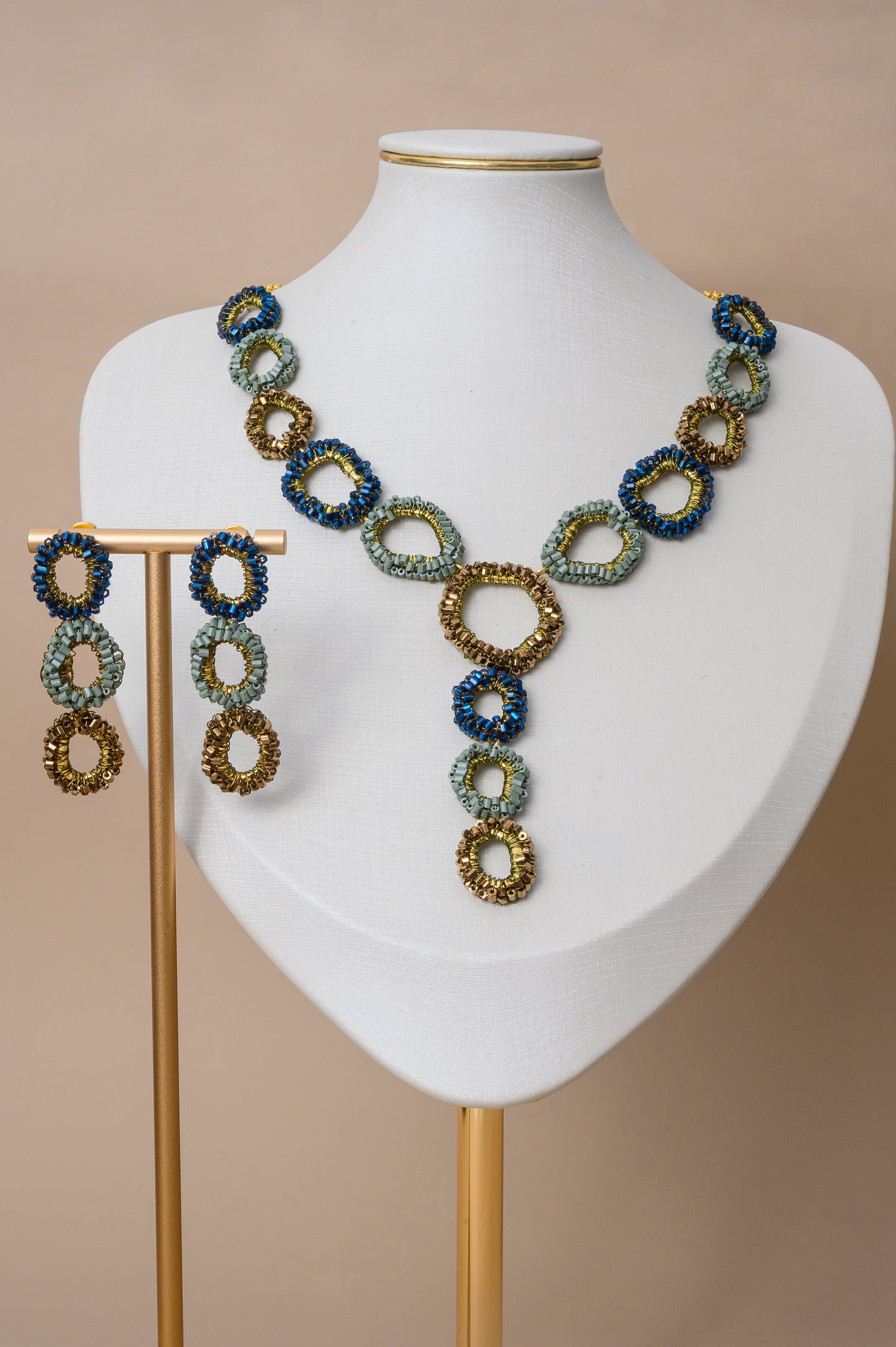 Riviera Mix Halo Cascade handmade crochet necklace with navy blue, sage green and bronze crystal halos and 18K gold filled wire.