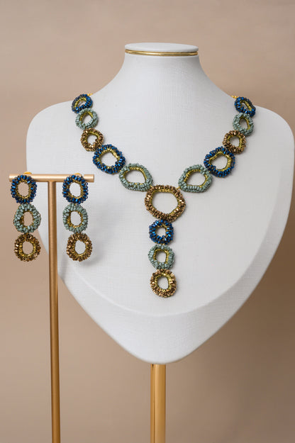 Riviera Mix Halo Cascade handmade crochet necklace with navy blue, sage green and bronze crystal halos and 18K gold filled wire.