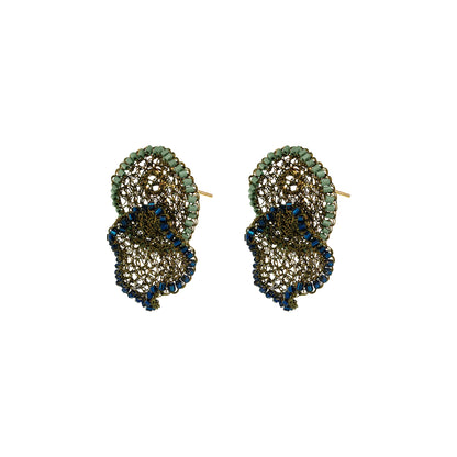 A pair of gold-toned drop earrings featuring textured, scalloped layers of green and dark blue rhinestones on a plain white background.