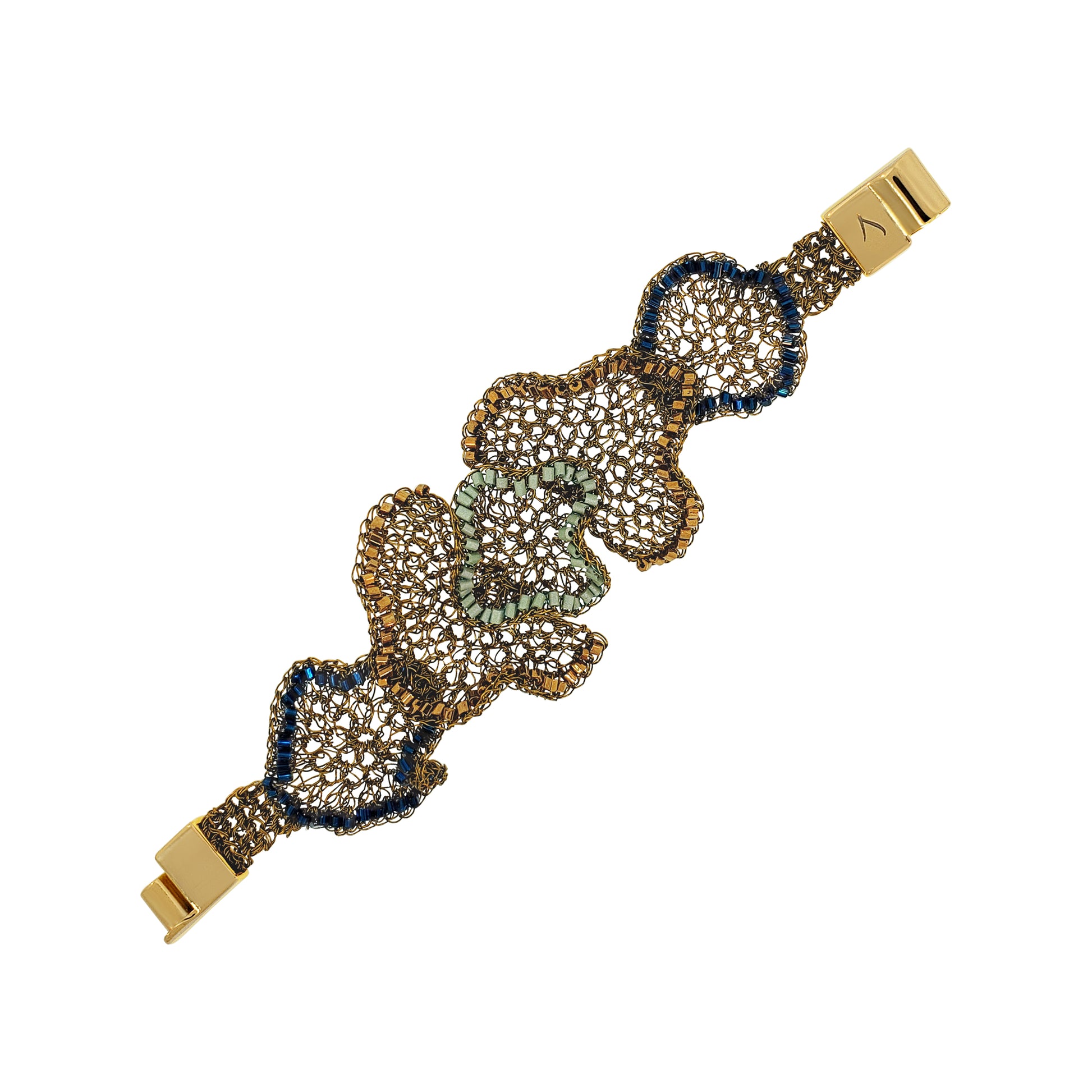 A gold-plated bracelet featuring three large, flower-like clusters of clear pavé stones in gold, bronze, and light green, with dark blue bezel-set accents, shown on a plain white background. Shop the Riviera Mix Jasmine Bracelet, handcrafted in Brazil with 18K gold filled wire and colorful accents. A lightweight statement cuff with unique floral texture.
