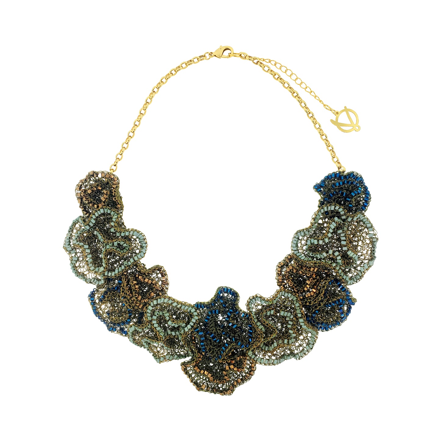 A statement collar necklace featuring layered, textured flower-like clusters of metallic beads in bronze, olive green, and deep blue, suspended from a gold-tone chain with a lobster clasp and toggle. Shop the Riviera Mix Jasmine Maxi Necklace, handcrafted in Brazil with 18K gold filled and enameled wire. A lightweight floral statement necklace in Riviera-inspired colors.