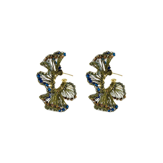 A pair of gold-toned statement earrings with a layered, textured design accented by small blue rhinestones, shown on a plain white background. Riviera Mix Rio Hoop handmade crochet earrings with ruffled deep blue, sage green and bronze accents in 18 karat gold filled and enameled wire.