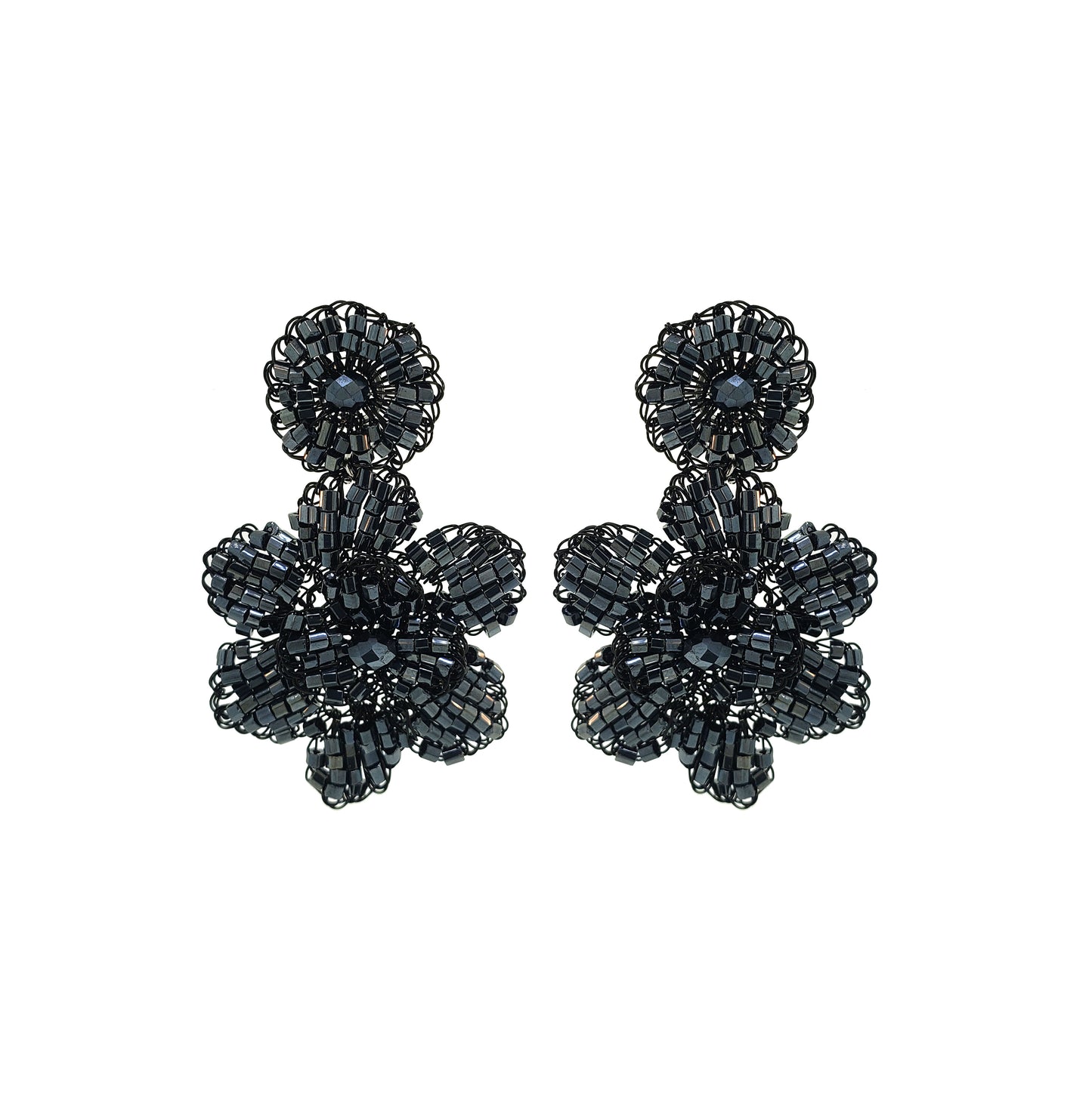 A pair of hand-crocheted floral earrings made with black enameled copper wire, displayed against a white background. Mini floral hand-crocheted dangle earrings handmade in Brazil with shiny black enameled wire and deep charcoal bead accents.