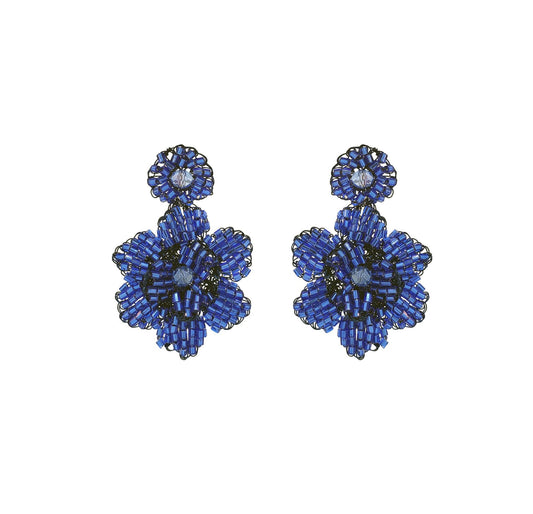 A pair of hand-crocheted floral earrings in blue, made from enameled wire, with hypoallergenic properties. Mini floral hand-crocheted earrings handmade in Brazil with enameled wire, lightweight artisan design, and delicate floral texture.