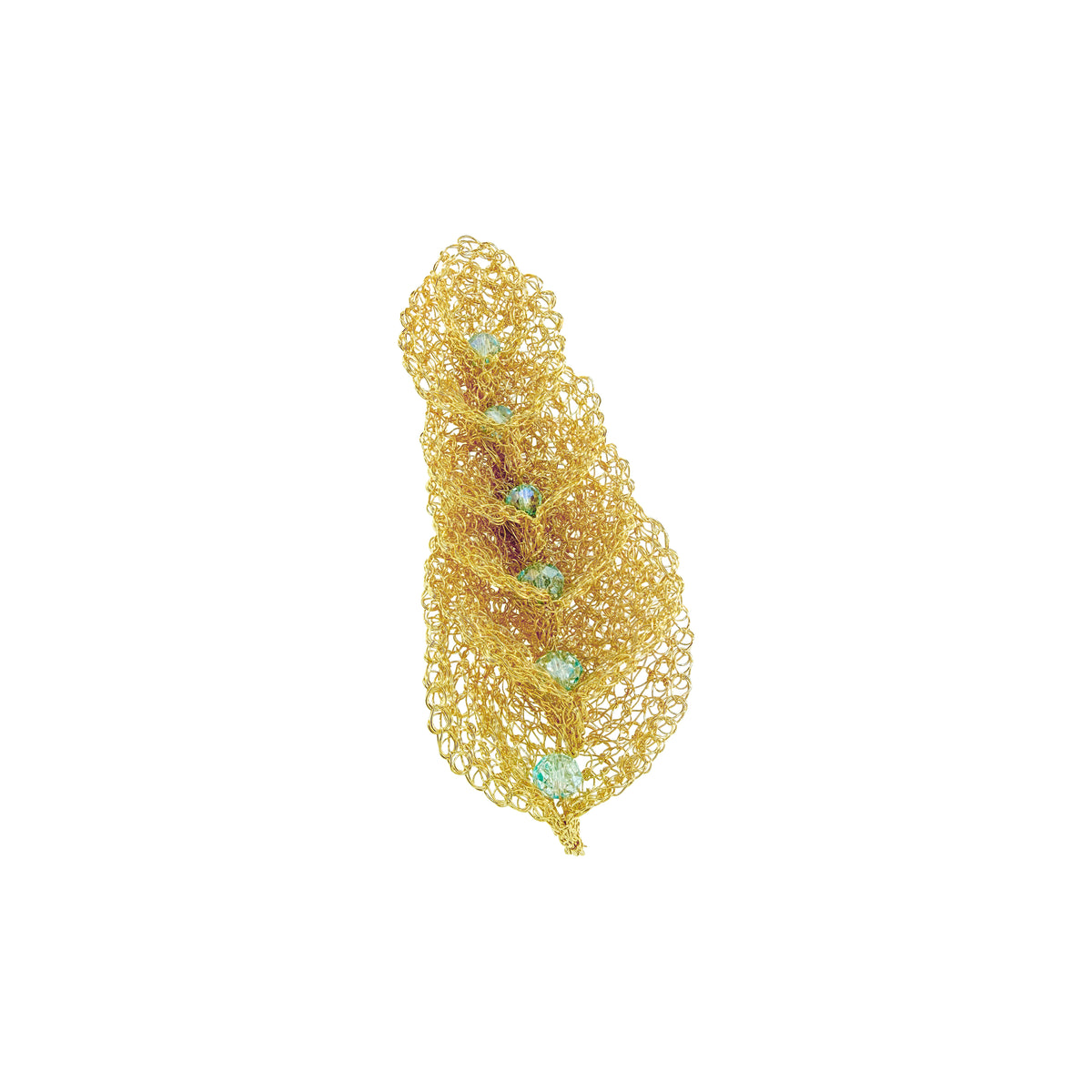 A gold-toned openwork mesh feather-shaped brooch with small light blue-green gemstone accents, shown on a plain white background. Discover the Seafoam Blue Calla Embrace Maxi Brooch. Hand-crocheted in Brazil with 18K gold-filled wire and sparkling seafoam crystals. Elegant wearable art.
