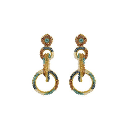 A pair of hand-crocheted earrings with gold-filled wire and blue and clear crystals. Interlocked link hand-crocheted earrings handmade in Brazil with 18 karat gold filled wire, aqua, ivory, champagne, and seafoam blue bead accents, sparkling crystals, and layered circular links.
