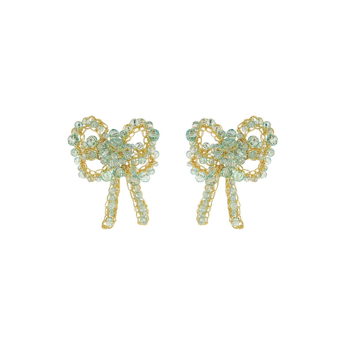 A pair of gold bow-shaped stud earrings embellished with light green faceted rhinestones, shown against a plain white background. Seafoam Bow Blossom Drop handmade crochet earrings featuring delicate bow-shaped designs with sparkling seafoam blue crystals, gold-filled wire, and dangling crystal details.