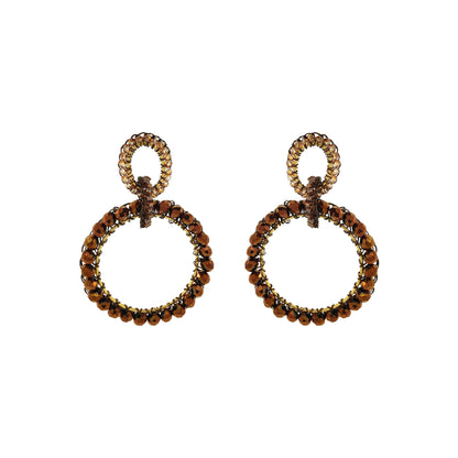 Pair of circular earrings with brown gemstones on a white background. Shop handcrafted double circle earrings featuring 18K gold-filled and enameled copper wire with sparkling crystals. Lightweight, hypoallergenic and handmade in Brazil.