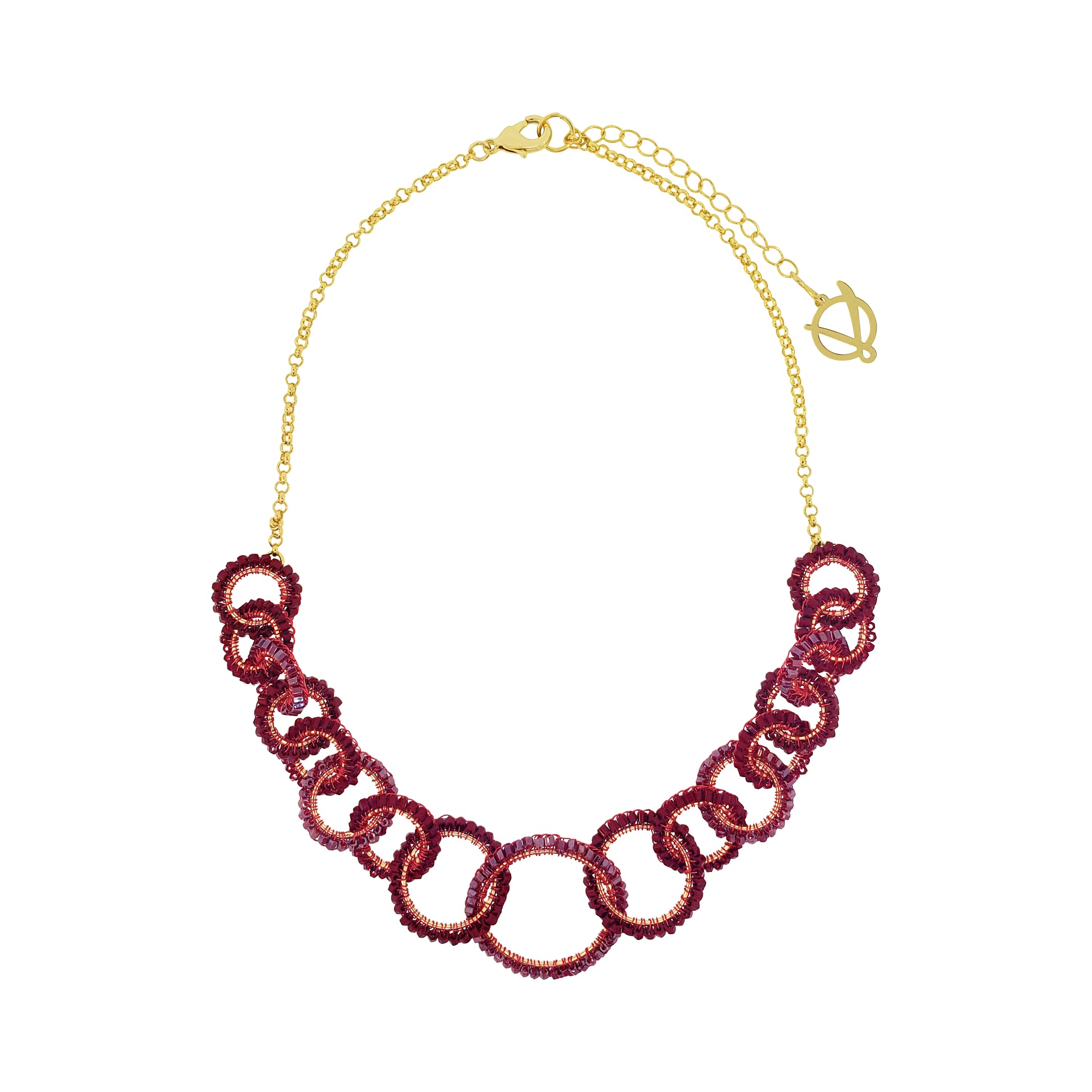 A gold-tone chain necklace featuring a row of interlocking links covered in deep burgundy sequins, presented on a clean white background. Lola handmade statement necklace with interlocking crochet links in burgundy enameled and 18K gold-filled copper wire.