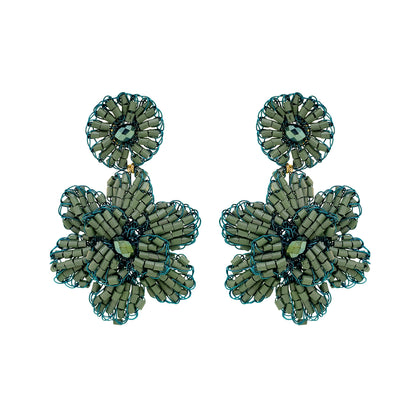 Mini floral hand-crocheted dangle earrings handmade in Brazil with shiny enameled wire and sparkling teal bead accents.