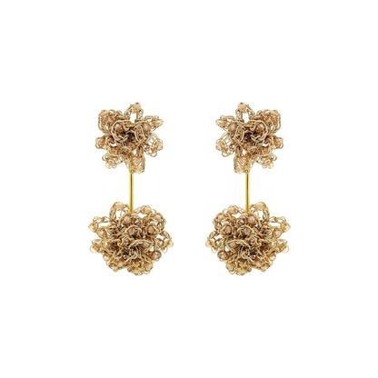 Pair of gold floral earrings on a white background. Hand-crocheted gold double mandala earrings with amber bead accents, handmade in Brazil with 18 karat gold filled wire.