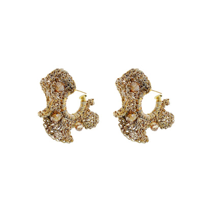 A pair of gold-toned filigree hoop earrings with small pearl-like bead accents, shown on a plain white background. Shop Nalu Hoops, handcrafted in Brazil with 18K gold-filled and enameled wire, sculptural crochet details and sparkling crystals. Lightweight and hypoallergenic.