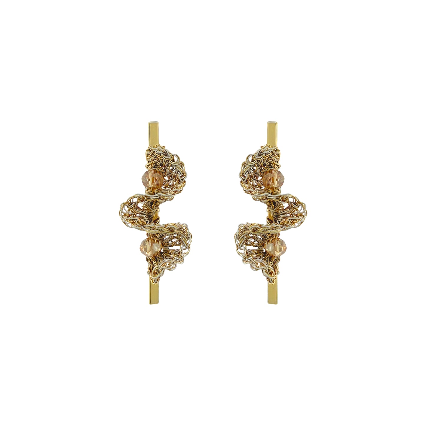A pair of gold-toned statement earrings with intricate, textured spiral wirework and small clear bead accents, displayed on a solid white background. Hand-crocheted gold bar drop earrings with sculptural ruffled wirework and champagne crystal accents, handmade in Brazil.