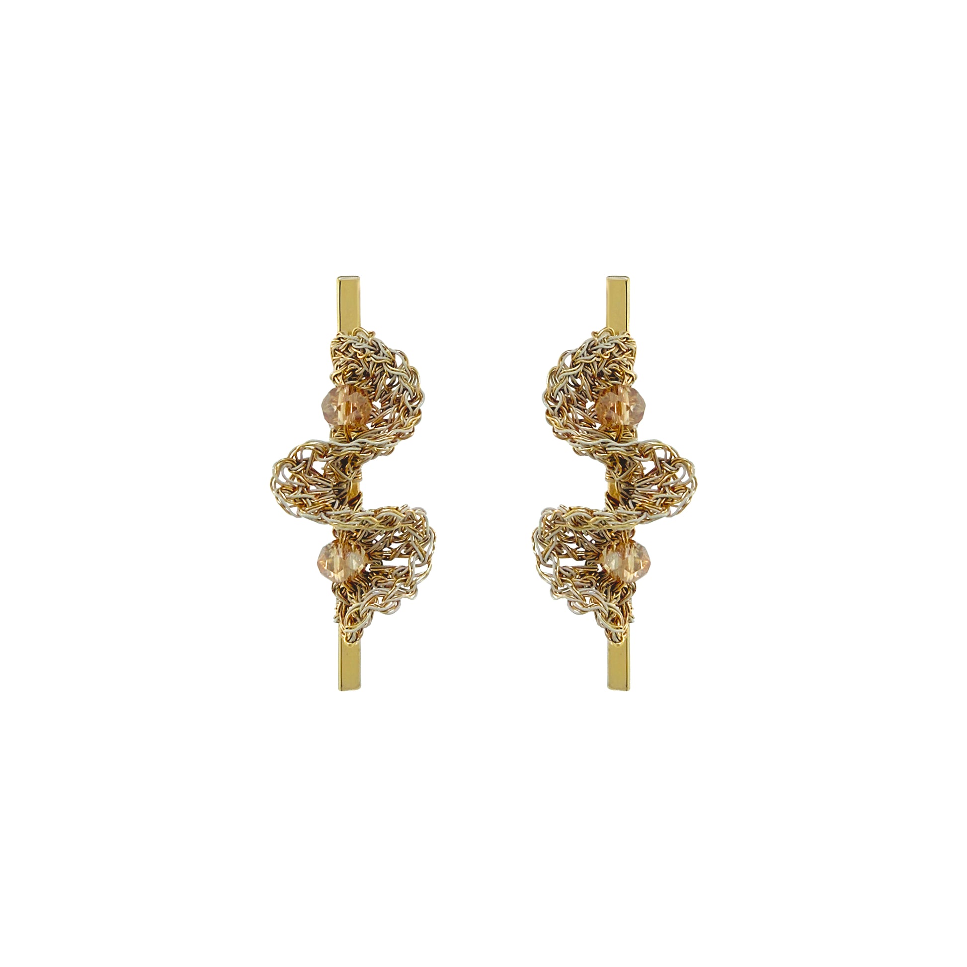 A pair of gold-toned statement earrings with intricate, textured spiral wirework and small clear bead accents, displayed on a solid white background. Hand-crocheted gold bar drop earrings with sculptural ruffled wirework and champagne crystal accents, handmade in Brazil.