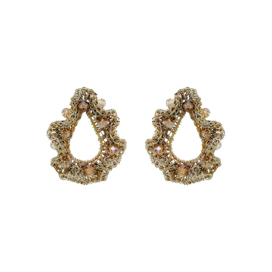 A pair of gold-toned teardrop-shaped earrings with intricate beadwork, sequins, and clear rhinestone accents, displayed on a solid white background. Nalu Teardrop hand-crocheted gold earrings with sculptural ruffled wirework and champagne crystal accents, handmade in Brazil.