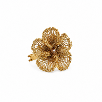 Gold floral hair clip on a white background. Floral hand-crocheted adjustable ring in 18 karat gold filled wire, handmade in Brazil, hypoallergenic nickel-free artisan statement jewelry.