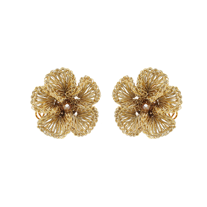 A pair of gold-colored hand-crocheted floral post earrings on a white background.